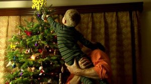 stock-footage-father-helping-son-decorate-christmas-tree